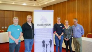 Dravet Syndrome Ireland Board members and our Clinical Researcher, Prof Norman Delanty standing beside a pull-up banner.