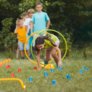 A group of children playing in a green field.