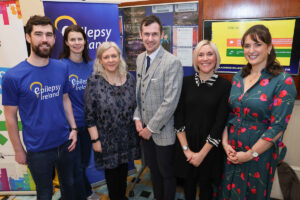 Six people, two males and four females, standing in front of the Epilepsy Ireland pull-up banner