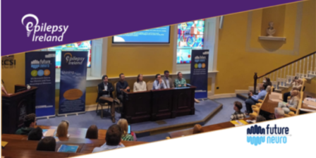 A panel of six people sitting at the front of a lecture theatre, with FutureNeuro and Epilepsy Ireland pull-up banners displayed on either side of the group.