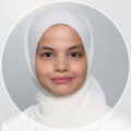 Professional headshot of a person wearing a white hijab, facing the camera with a neutral expression against a light grey background.
